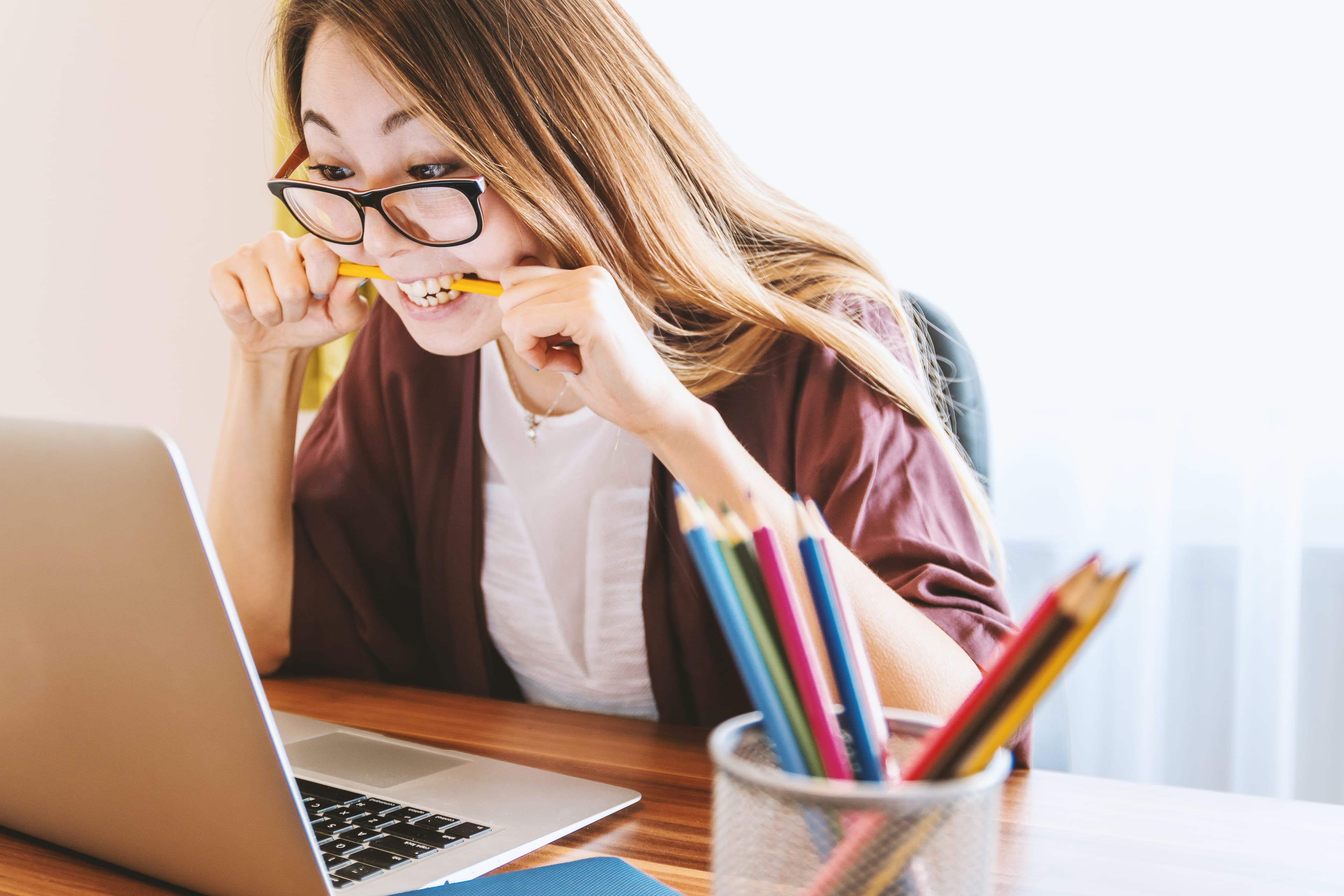 Woman Contemplating on a Laptop