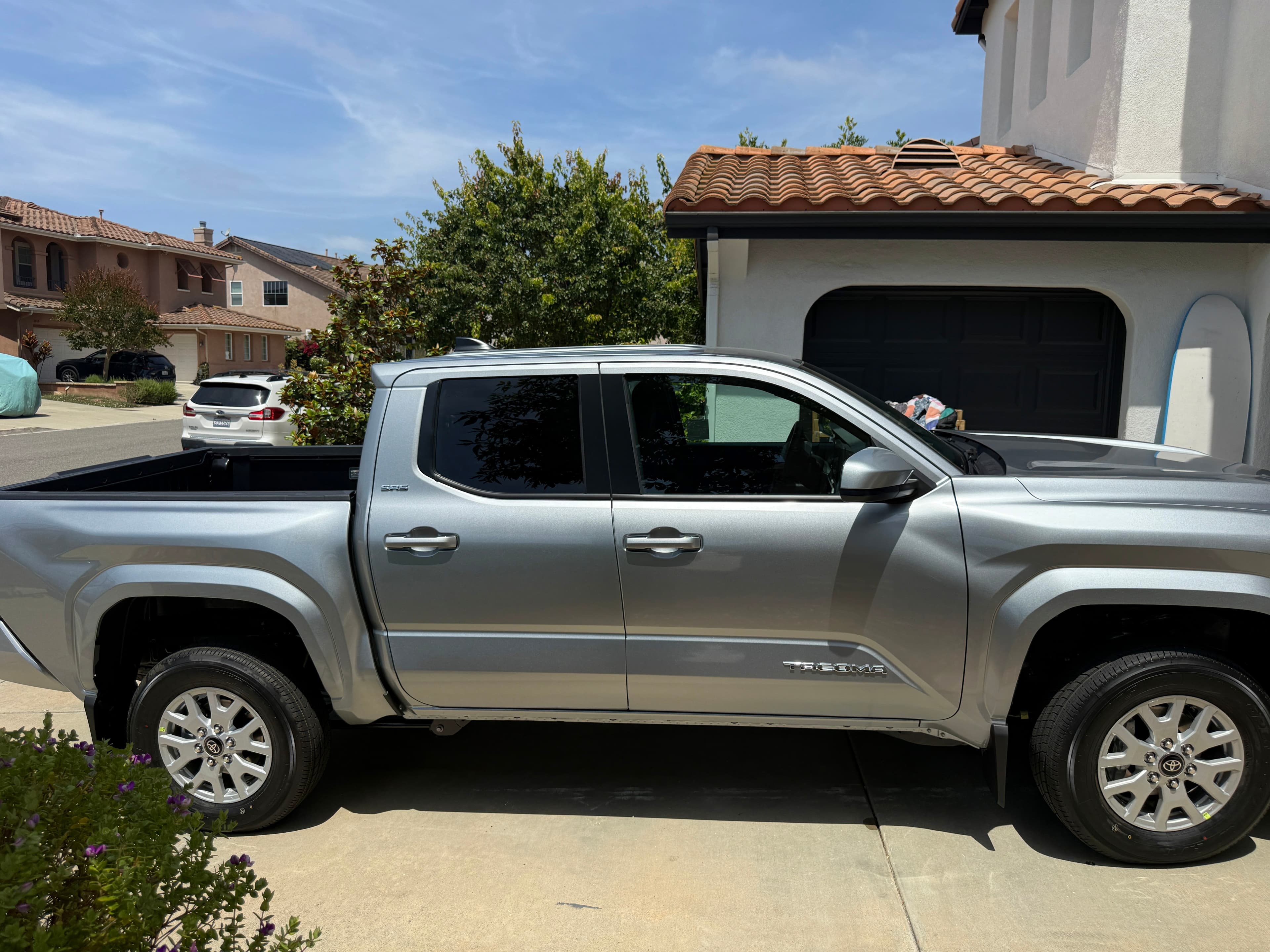 A silver Toyota Tacoma parked on a residential driveway